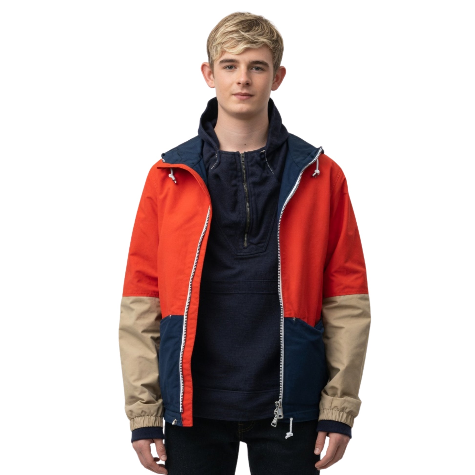 Person wearing a colorful jacket with red, blue, and beige sections on a white background