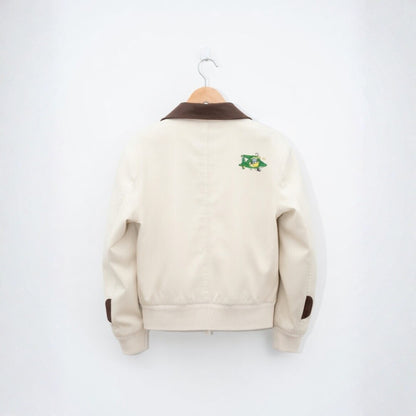 Beige jacket with brown accents on a hanger against a white background