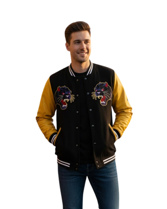 Man wearing a black and yellow varsity jacket with panther logos on a white background