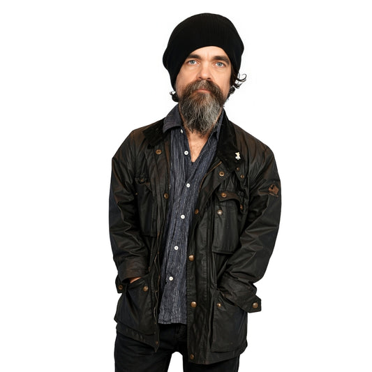 Man wearing a black jacket and beanie on a white background