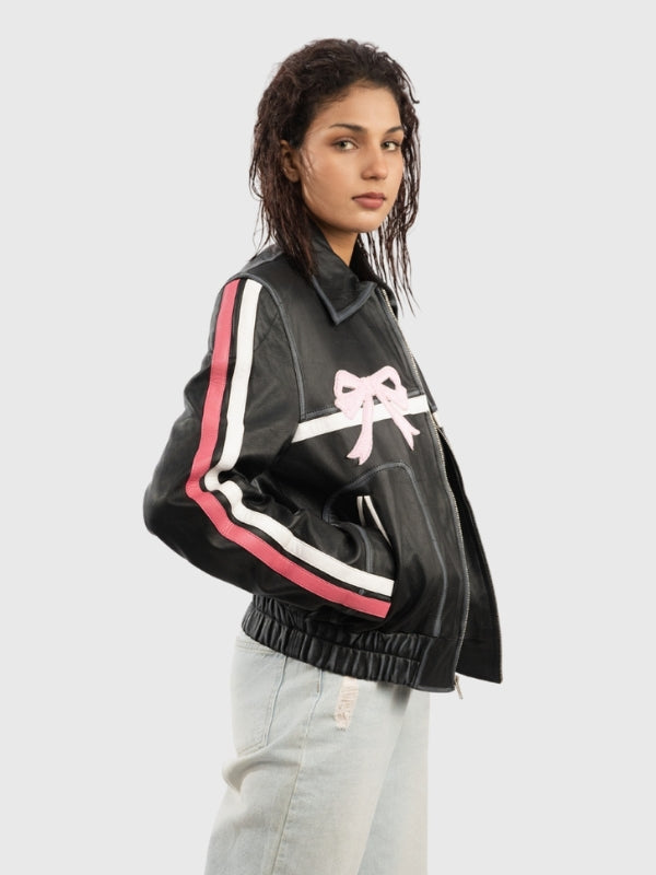 Person wearing a black jacket with pink and white accents on a light gray background