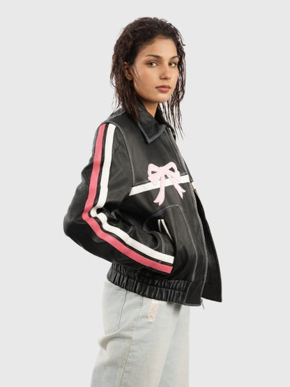 Person wearing a black jacket with pink and white accents on a light gray background