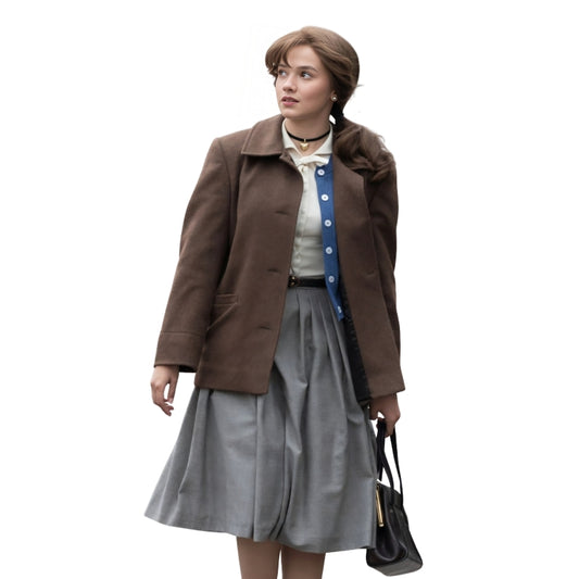 Woman wearing a brown leather jacket holding a gun on a white background