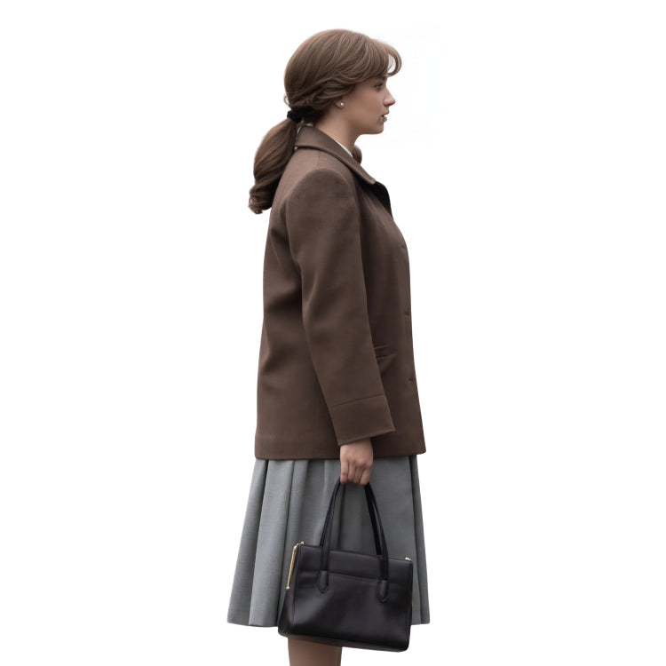 Woman wearing a brown coat and gray skirt holding a black handbag on a white background