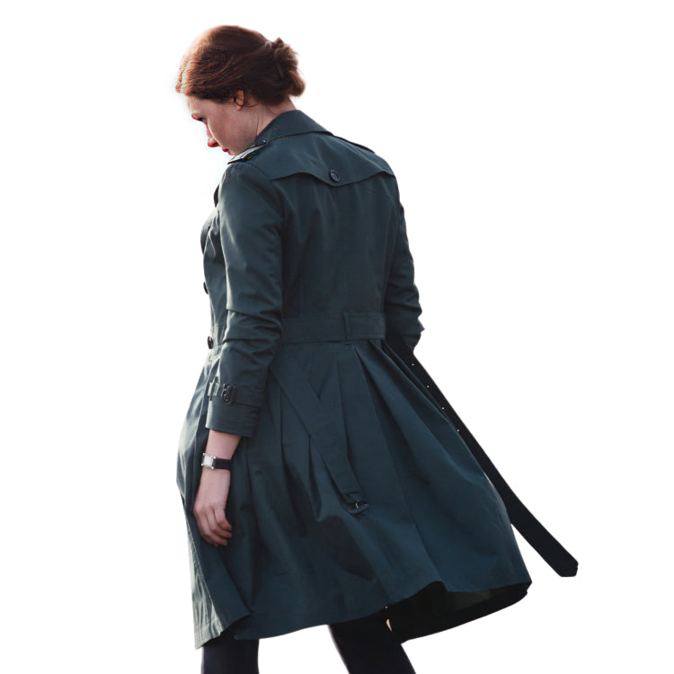 Woman wearing a dark green trench coat on a white background