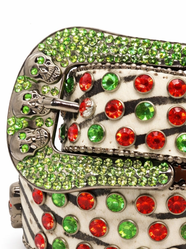 Decorative belt buckle with green and red gemstones on a white background