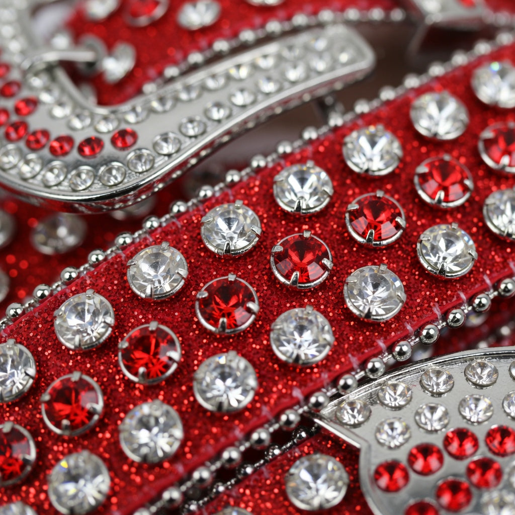Close-up of a red belt with silver and red gemstones