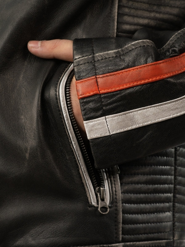 Close-up of a person wearing a black leather jacket with a zipper detail.