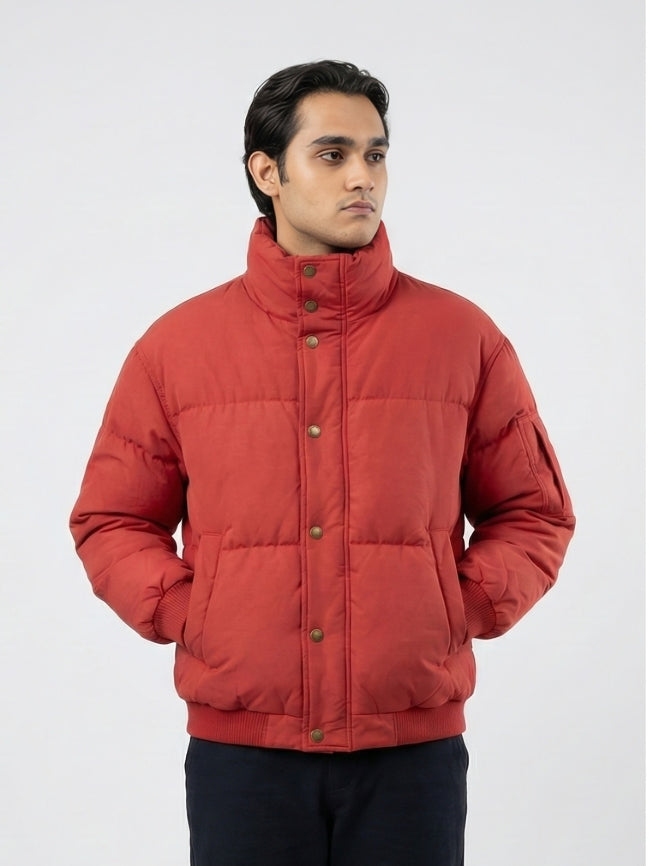 Man wearing a red puffer jacket on a white background
