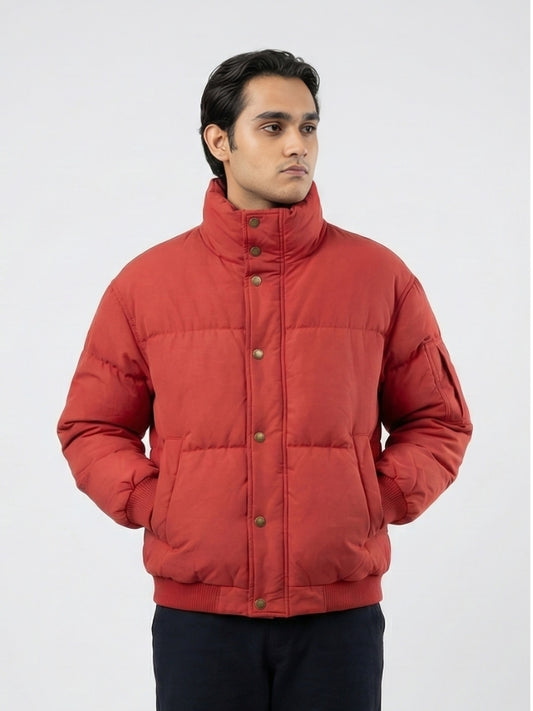 Man wearing a red puffer jacket on a white background