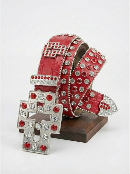 Red belt with silver and red embellishments on a wooden stand against a white background