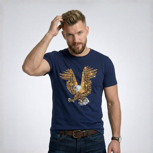 Man wearing a navy blue t-shirt with an eagle design on a plain background
