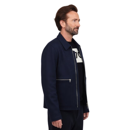 Man wearing a navy jacket with a white logo on a white background