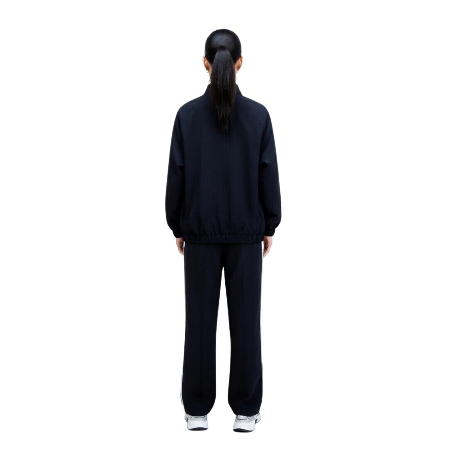 Person wearing a black tracksuit on a white background