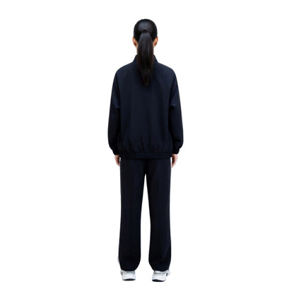 Person wearing a black tracksuit on a white background