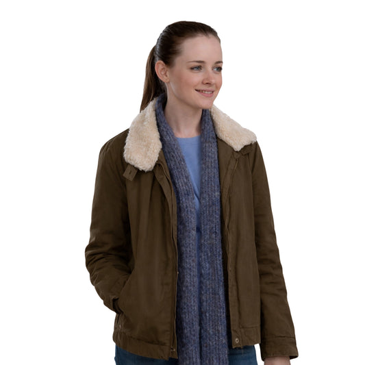 Woman wearing a brown jacket with a fur-lined hood and a blue scarf on a white background