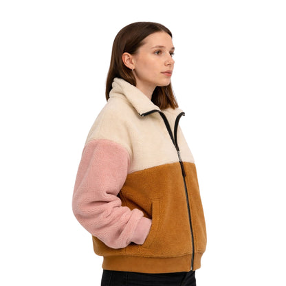 Woman wearing a color-blocked fleece jacket with beige, pink, and brown sections on a white background.