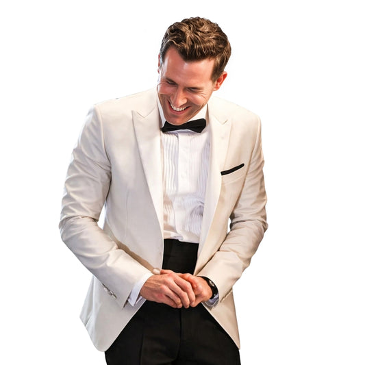 Man in a white tuxedo with a black bow tie on a white background