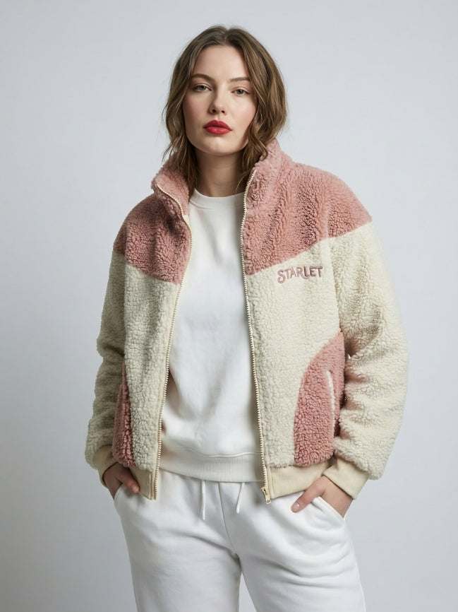 Woman wearing a two-tone fleece jacket with 'Starlet' branding on a plain background