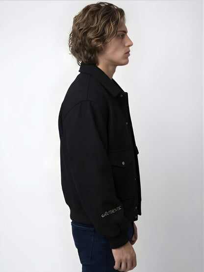 Person wearing a black jacket with 'Authentic' branding on a white background