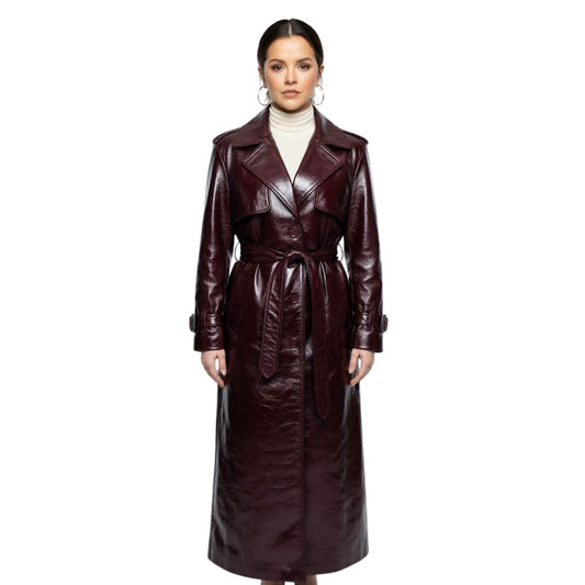 Woman wearing a long brown leather coat on a white background