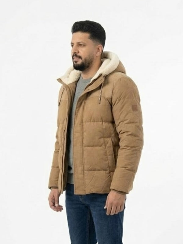 Man wearing a brown puffer jacket with a white hood on a light gray background