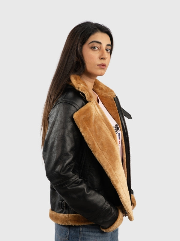 Person wearing a black leather jacket with brown shearling lining on a white background