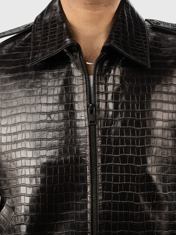 Close-up of a black textured jacket with a zipper