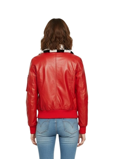 Person wearing a red leather jacket and blue jeans on a white background