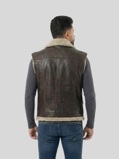 Man wearing a brown leather vest with sheepskin lining on a light gray background