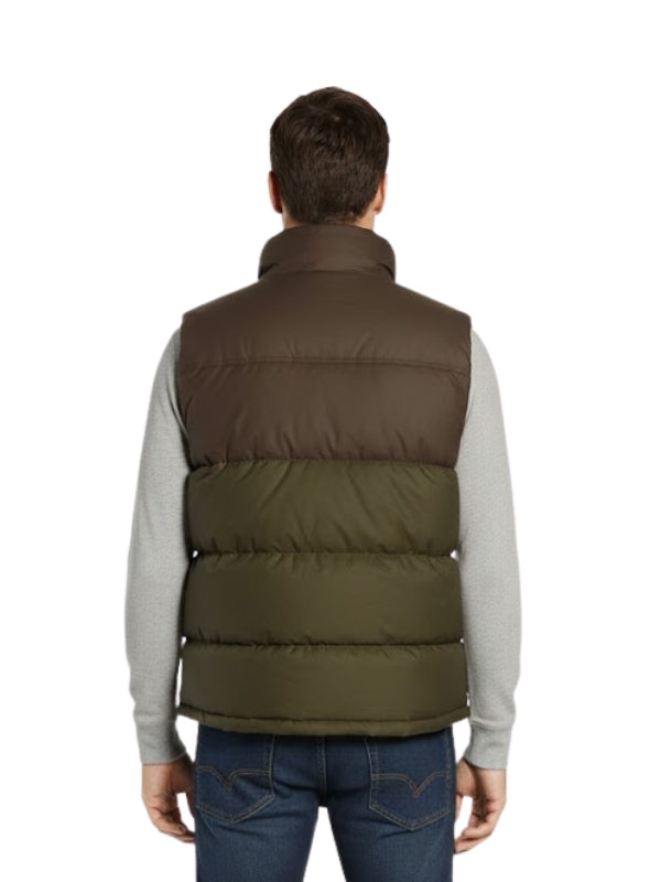 Man wearing a two-tone puffer vest with a white background