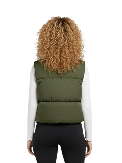 Person wearing a green puffer vest on a white background