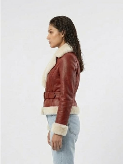 Woman wearing a brown leather jacket with white fur trim on a white background