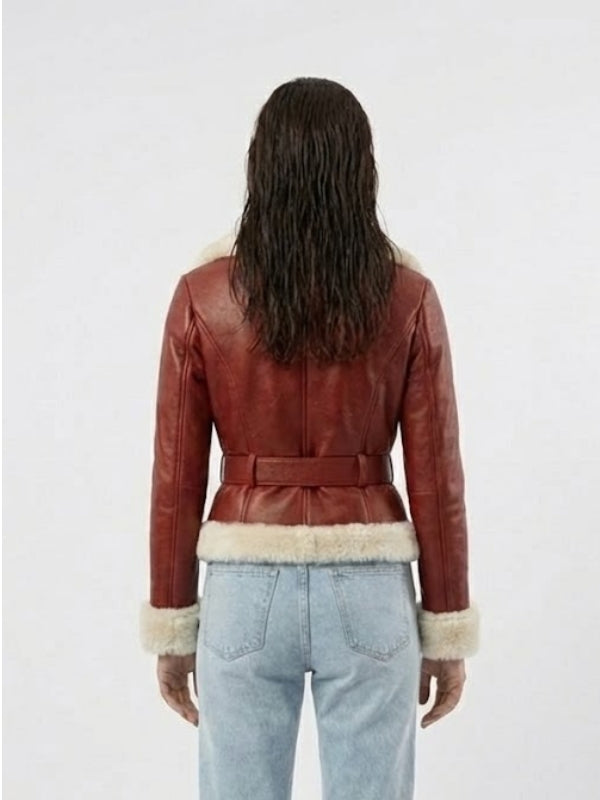 Person wearing a red leather jacket with fur trim on a white background