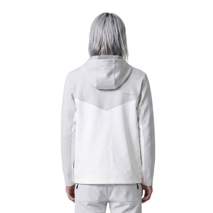 Person wearing a light gray hoodie with a subtle design on the back against a white background