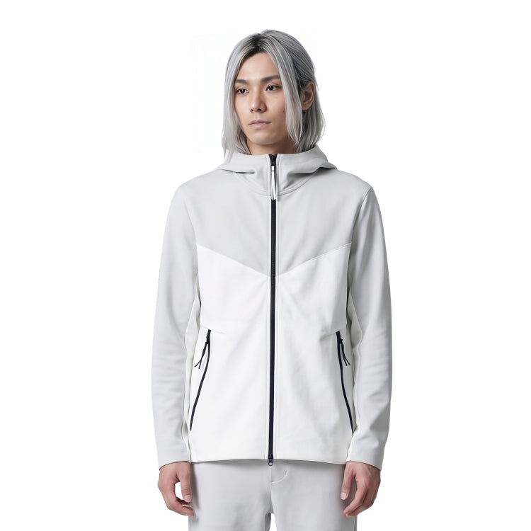 Person wearing a white jacket with black zippers on a white background