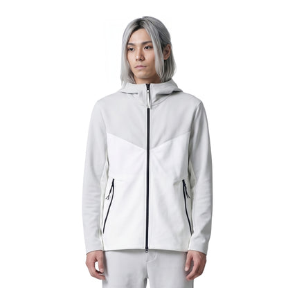 Person wearing a white jacket with black zippers on a white background