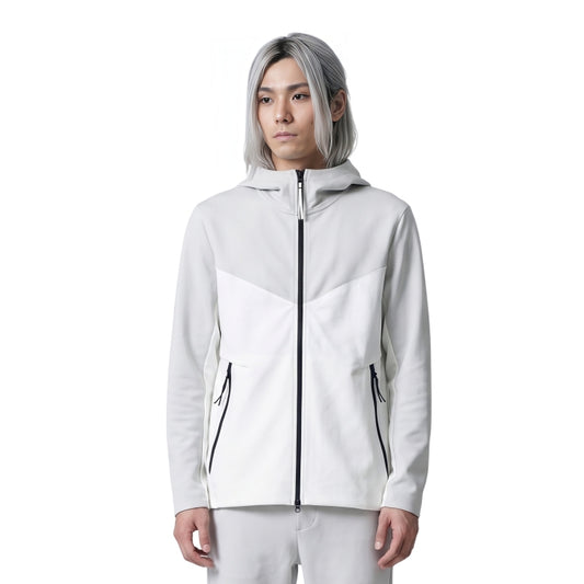 Person wearing a white jacket with black zippers on a white background