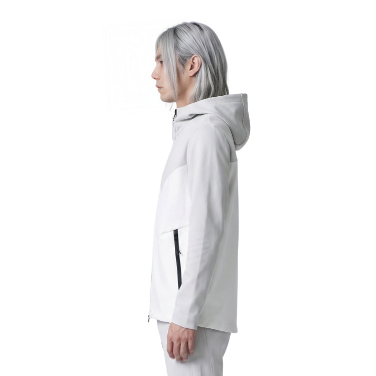Person wearing a white hooded jacket on a white background