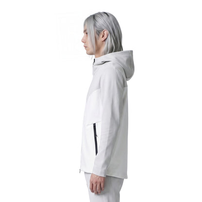 Person wearing a white hooded jacket on a white background
