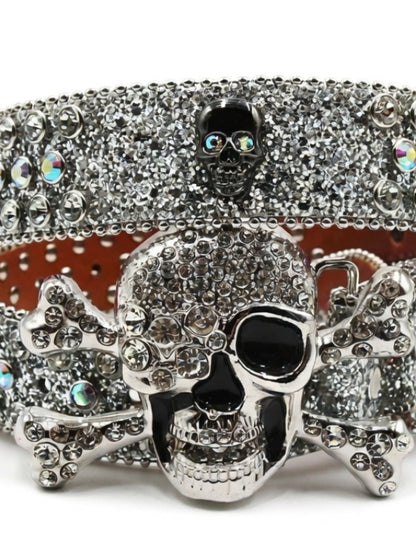 Silver skull belt buckle with rhinestones on a white background