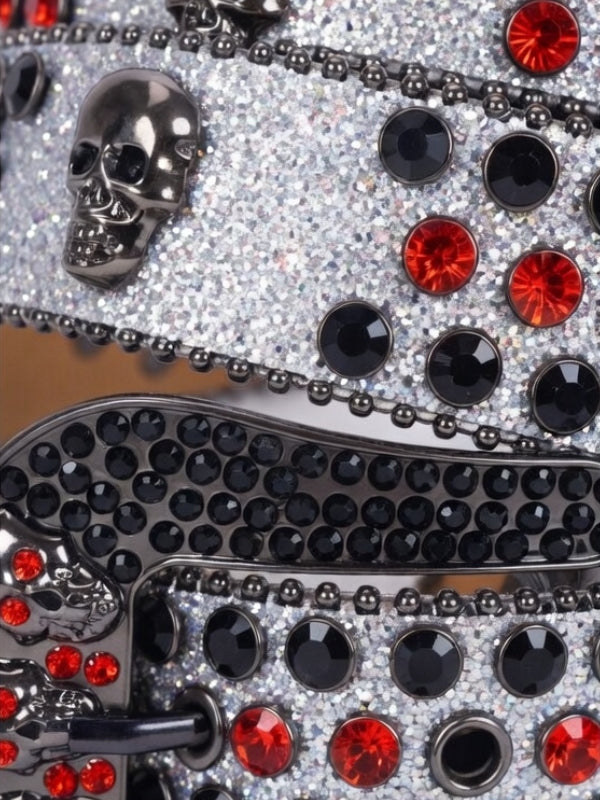 Decorative item with black and red gemstones on a reflective surface