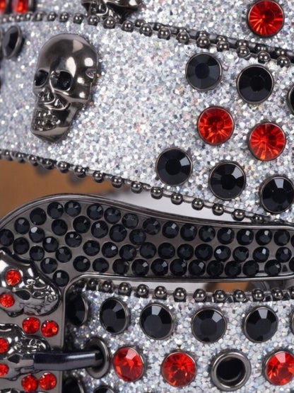 Decorative item with black and red gemstones on a reflective surface