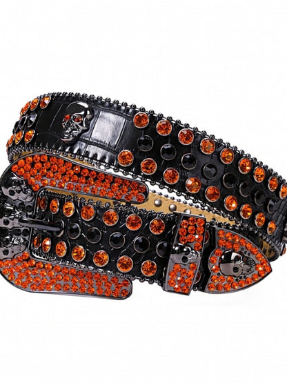 Black belt with orange rhinestones and skull designs on a white background