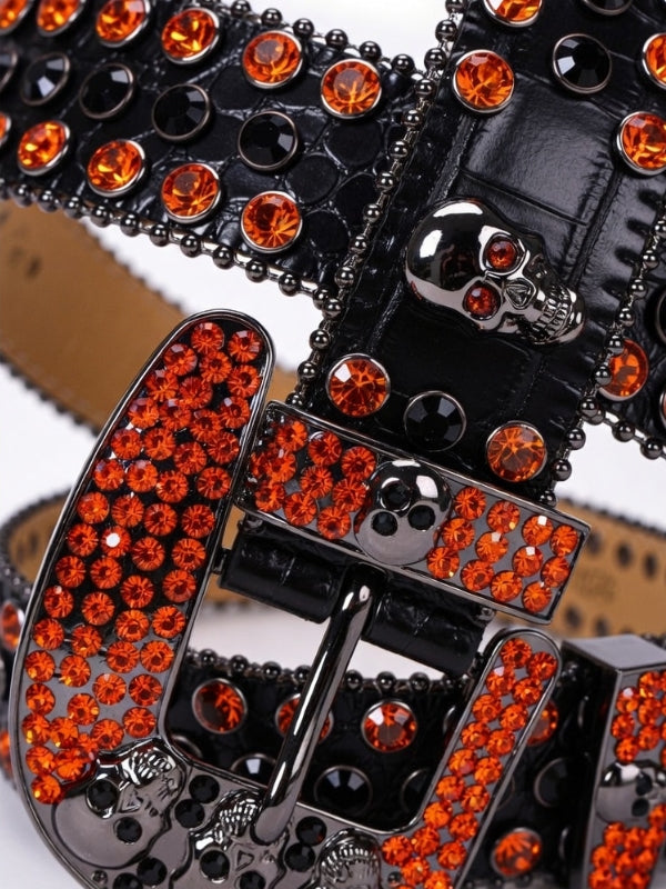 Black belt with orange rhinestone buckle on a white background