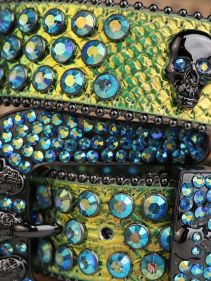 Decorative clutch with rhinestones and skull design on a green patterned background