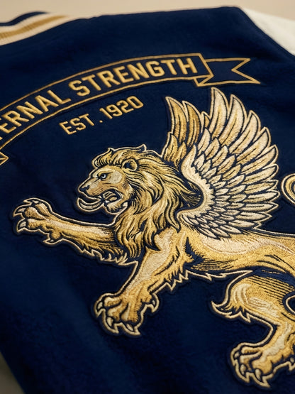 Embroidered lion design on a blue fabric with 'Eternal Strength' text.