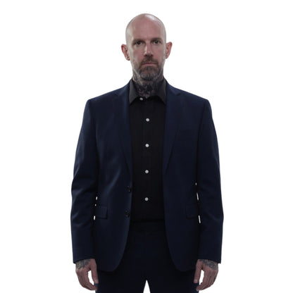 Man wearing a dark suit and shirt on a white background