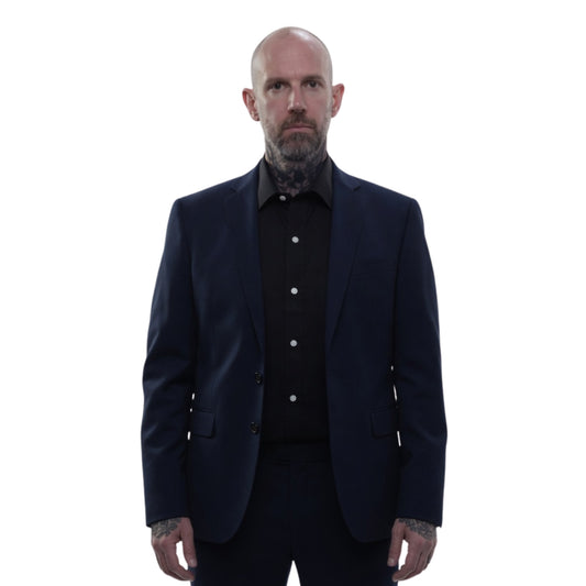Man wearing a dark suit and shirt on a white background