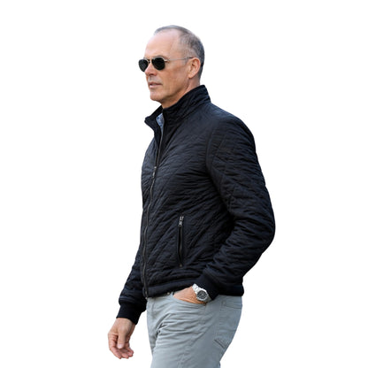 Man wearing a black jacket and sunglasses on a white background